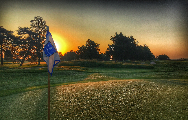 Flag on hole of golf course green